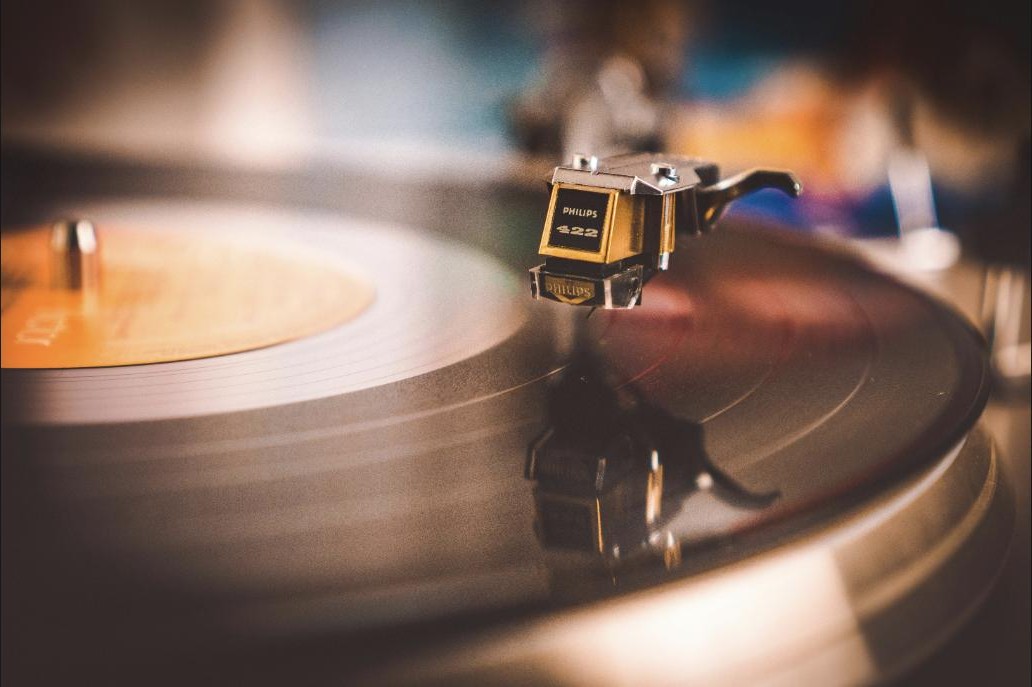 A close-up of a needle on a spinning vinyl record