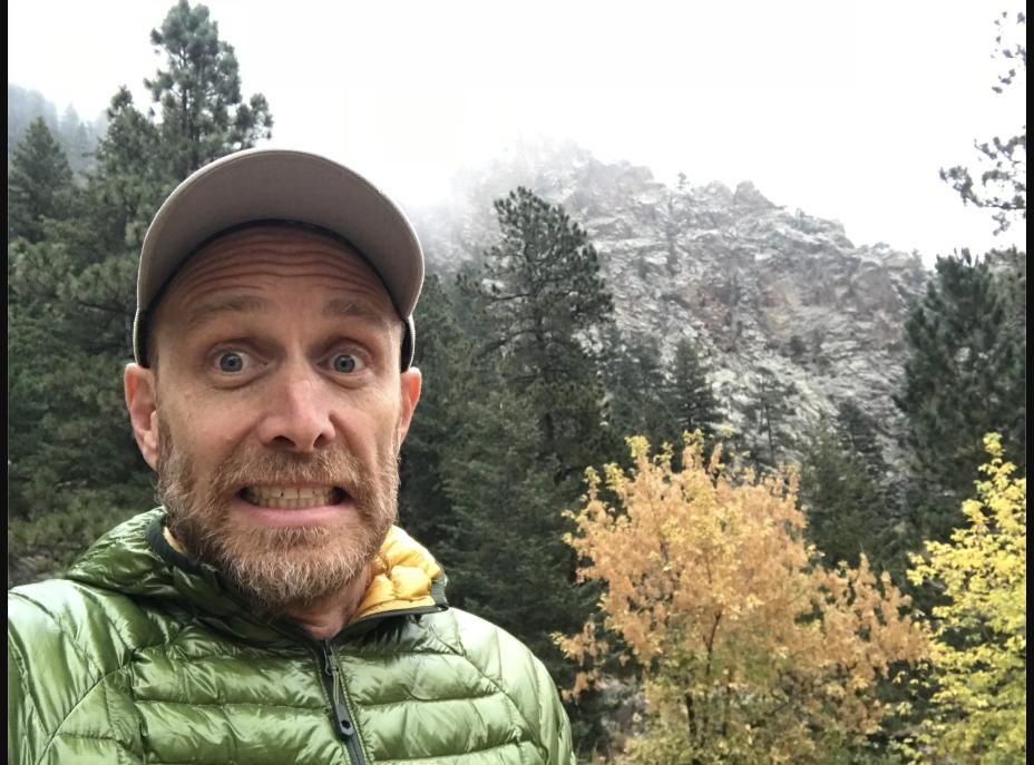 Parker taking a surprised selfie on a foggy hike in the mountains